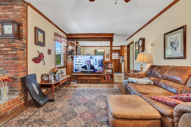 living room with hardwood / wood-style floors, crown molding, and ceiling fan