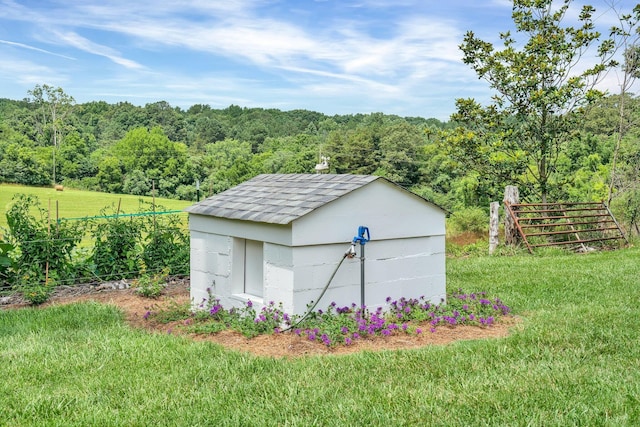 view of outbuilding featuring a yard