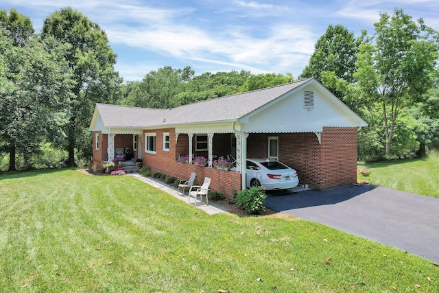 ranch-style home featuring a carport and a front lawn