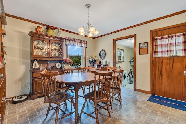 dining area featuring washer / clothes dryer, crown molding, and an inviting chandelier