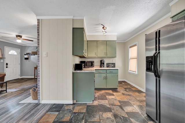 kitchen with crown molding, ceiling fan, appliances with stainless steel finishes, a textured ceiling, and green cabinetry