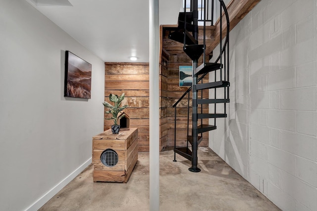 staircase featuring concrete flooring