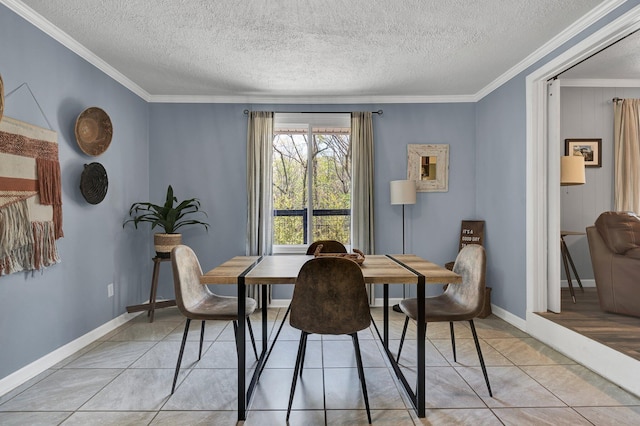 dining room featuring ornamental molding, light tile patterned flooring, and a textured ceiling