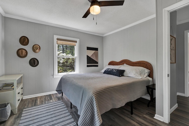 bedroom with crown molding, dark wood-type flooring, a textured ceiling, and ceiling fan