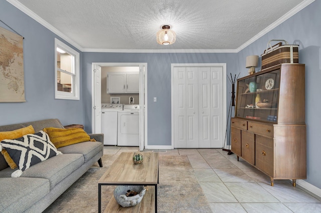 tiled living room with washing machine and dryer, ornamental molding, and a textured ceiling