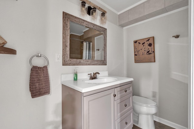 bathroom with vanity, ornamental molding, toilet, and walk in shower