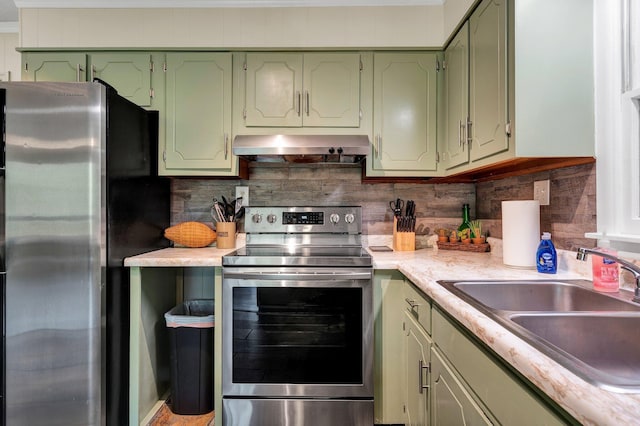 kitchen with sink, stainless steel appliances, tasteful backsplash, ventilation hood, and green cabinetry