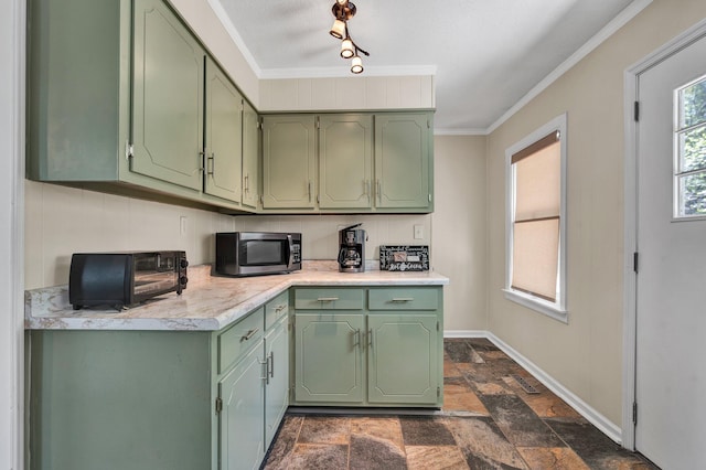 kitchen with backsplash, ornamental molding, rail lighting, and green cabinets