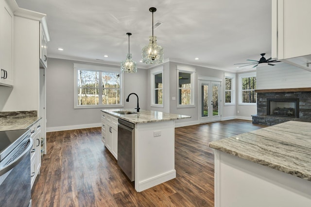 kitchen with sink, white cabinetry, a center island with sink, appliances with stainless steel finishes, and pendant lighting