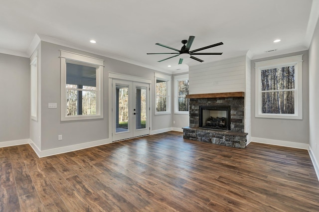 unfurnished living room featuring dark wood-type flooring, a wealth of natural light, ornamental molding, and french doors