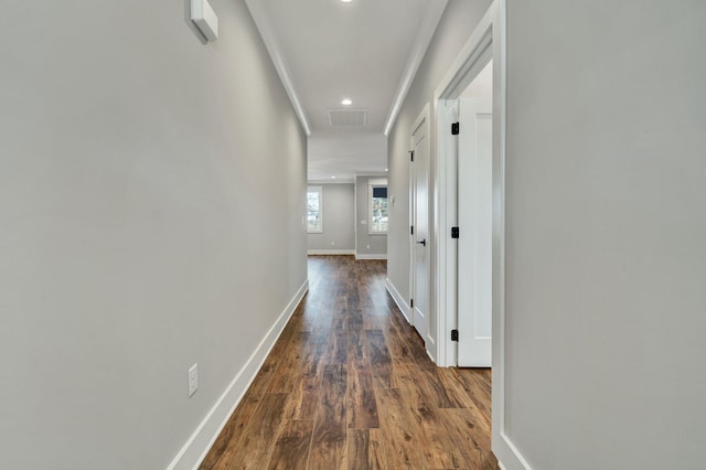 hall featuring crown molding and dark wood-type flooring