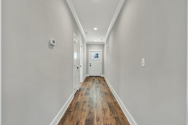 hallway featuring ornamental molding and dark hardwood / wood-style floors