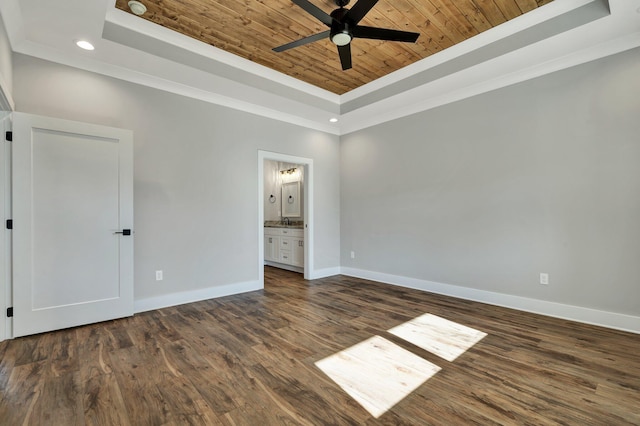 unfurnished bedroom with ensuite bath, ceiling fan, a tray ceiling, dark hardwood / wood-style flooring, and wooden ceiling