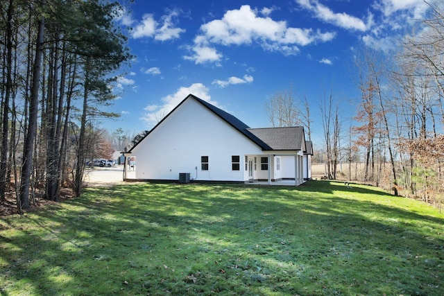 rear view of property with a yard and central AC unit