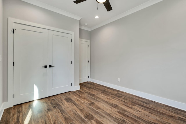 unfurnished bedroom featuring crown molding, dark hardwood / wood-style floors, ceiling fan, and a closet