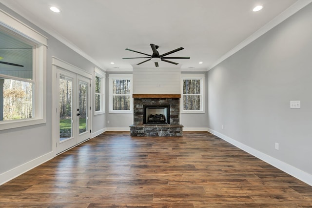 unfurnished living room featuring a fireplace, dark wood-type flooring, ornamental molding, and ceiling fan