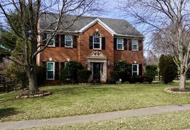 colonial inspired home with a front lawn