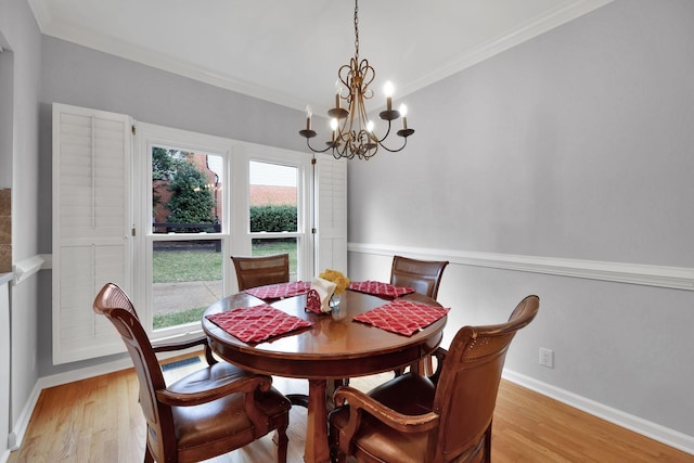 dining space with ornamental molding, a healthy amount of sunlight, and light hardwood / wood-style floors