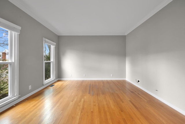 unfurnished room featuring ornamental molding and light hardwood / wood-style floors