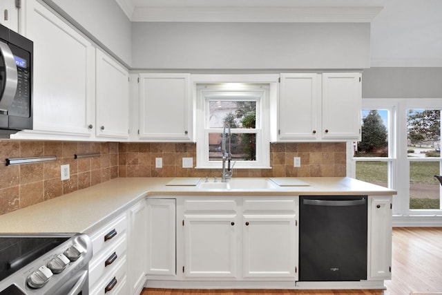 kitchen with dishwasher, sink, decorative backsplash, and white cabinets