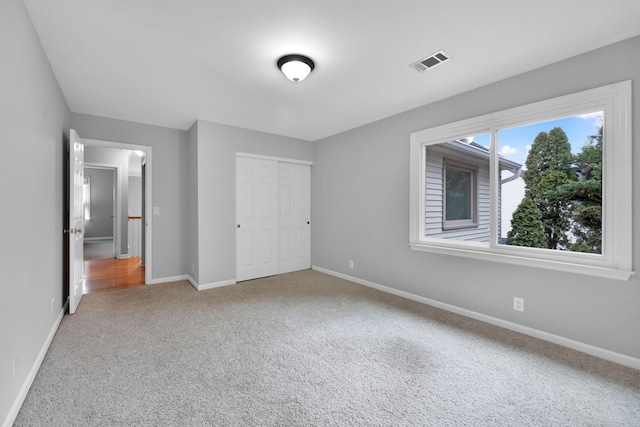 unfurnished bedroom featuring carpet floors and a closet