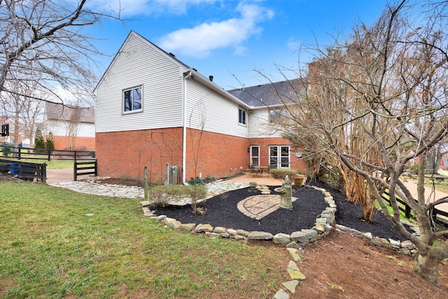 rear view of house with a yard and a patio area