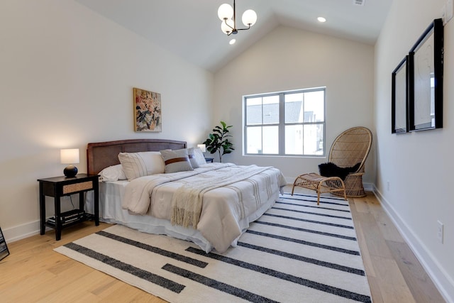 bedroom with high vaulted ceiling and light hardwood / wood-style flooring