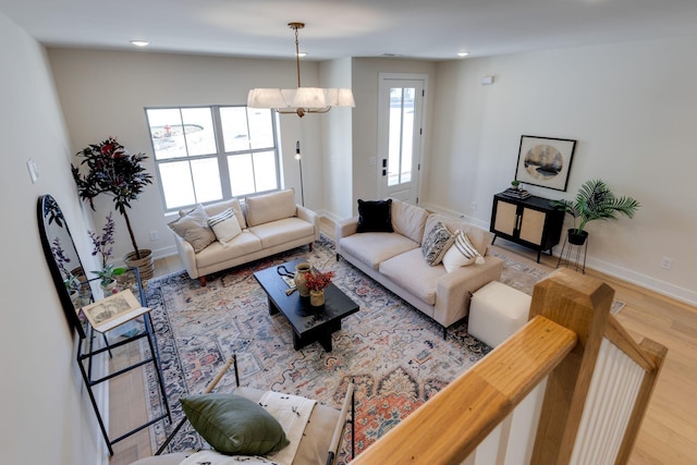 living room with hardwood / wood-style flooring and a chandelier