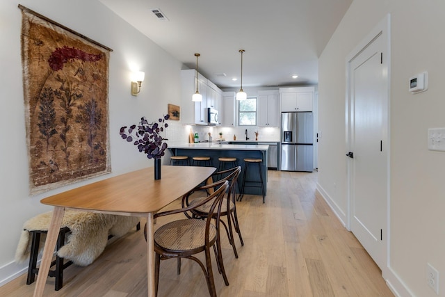 dining area with light wood-type flooring