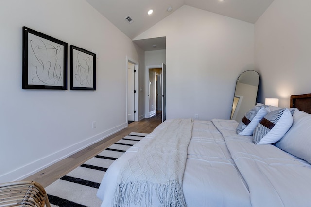 bedroom featuring lofted ceiling and hardwood / wood-style flooring