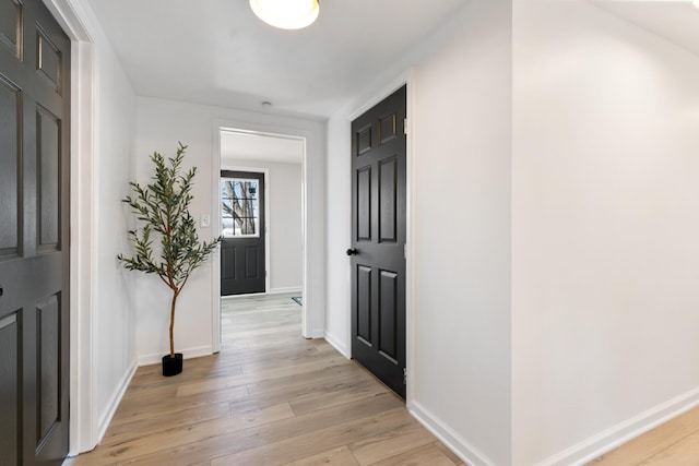 hallway with light hardwood / wood-style floors