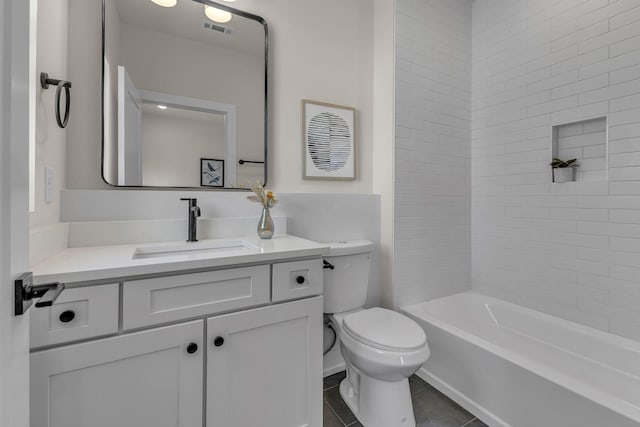 full bathroom with tile patterned floors, toilet, tiled shower / bath combo, and vanity