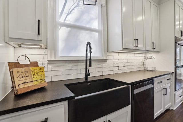 kitchen with sink, white cabinetry, dark hardwood / wood-style floors, decorative backsplash, and stainless steel dishwasher