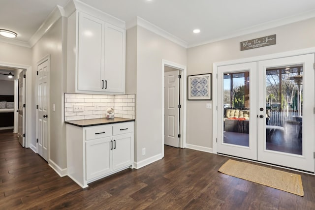 interior space with crown molding, dark wood-type flooring, and french doors