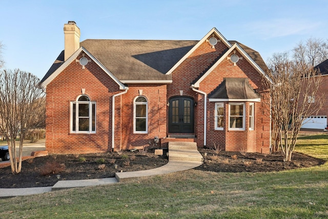 view of front of home featuring a front lawn and french doors