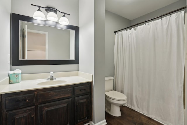 bathroom featuring vanity, toilet, and wood-type flooring