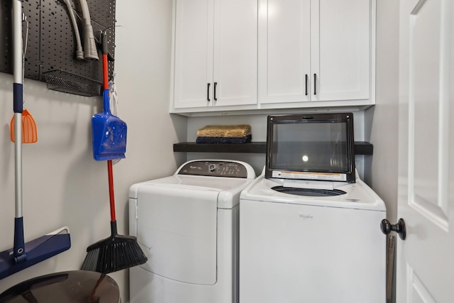 laundry area with cabinets and washing machine and clothes dryer