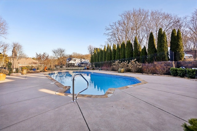 view of swimming pool with a patio