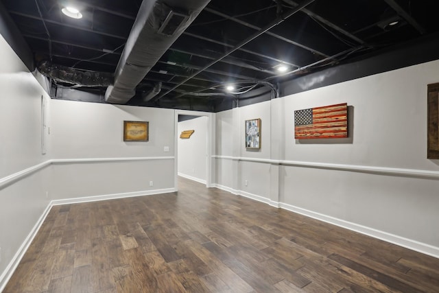 basement with dark hardwood / wood-style floors