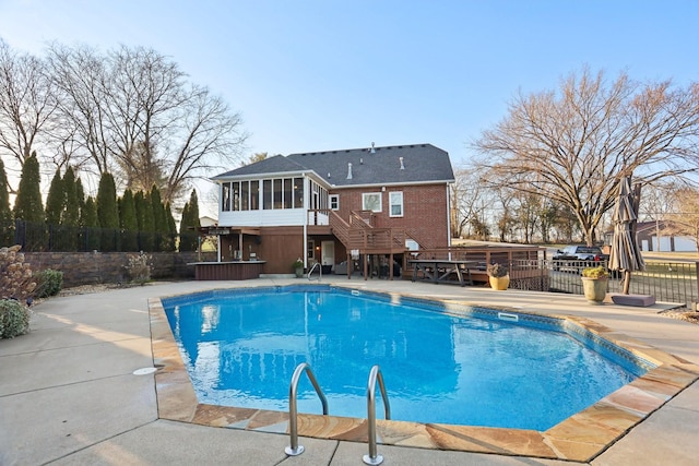 view of pool with a patio area and a sunroom