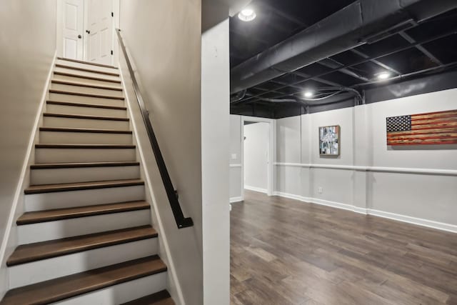 stairs featuring wood-type flooring