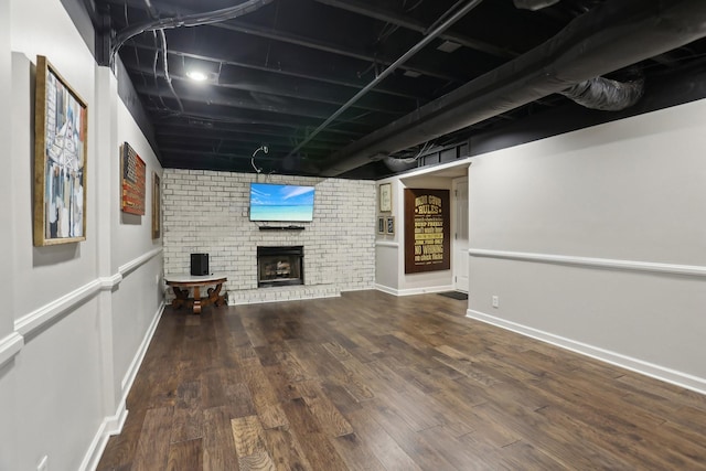 basement with hardwood / wood-style flooring and a fireplace