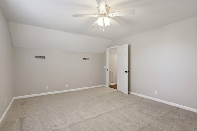 carpeted empty room featuring lofted ceiling and ceiling fan