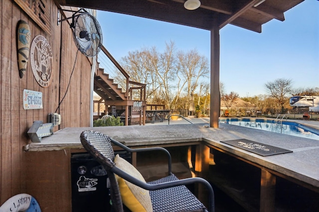 view of patio with a community pool and an outdoor bar