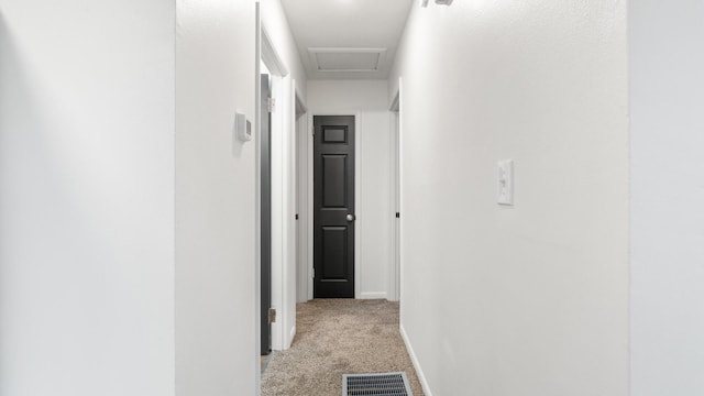 hallway with light colored carpet