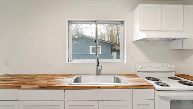 kitchen featuring white cabinetry, butcher block countertops, sink, and electric range