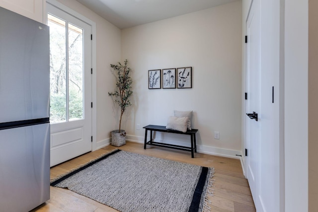 foyer entrance with plenty of natural light and light hardwood / wood-style flooring