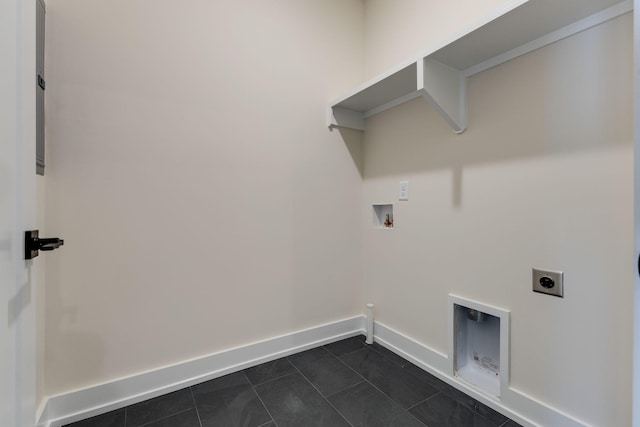 laundry area featuring electric dryer hookup, dark tile patterned flooring, and hookup for a washing machine