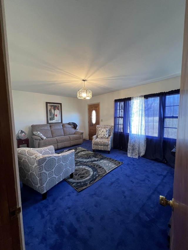 living room with carpet floors and a chandelier