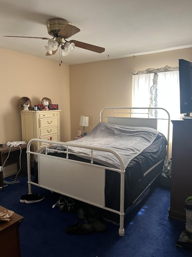 bedroom with dark carpet and ceiling fan